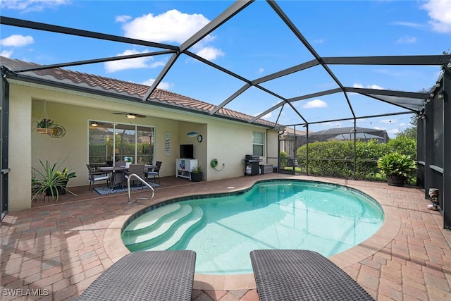 view of pool featuring a lanai, a patio area, and a grill