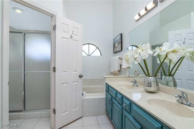 bathroom featuring vanity, tile patterned flooring, and plus walk in shower