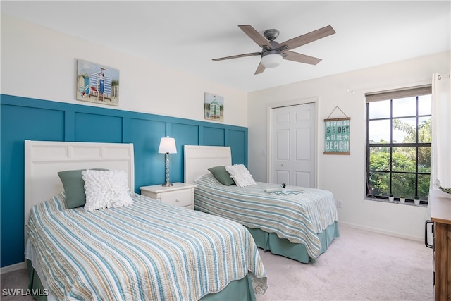 bedroom with light carpet, a closet, and ceiling fan