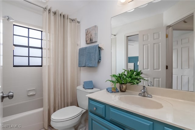 full bathroom featuring vanity, shower / bath combo, and toilet