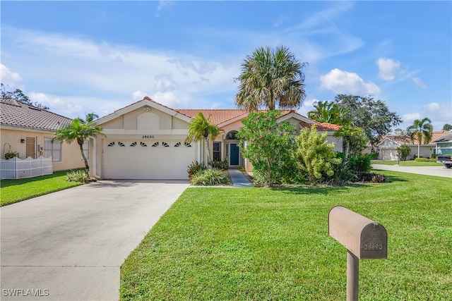 view of front of home with a front lawn and a garage