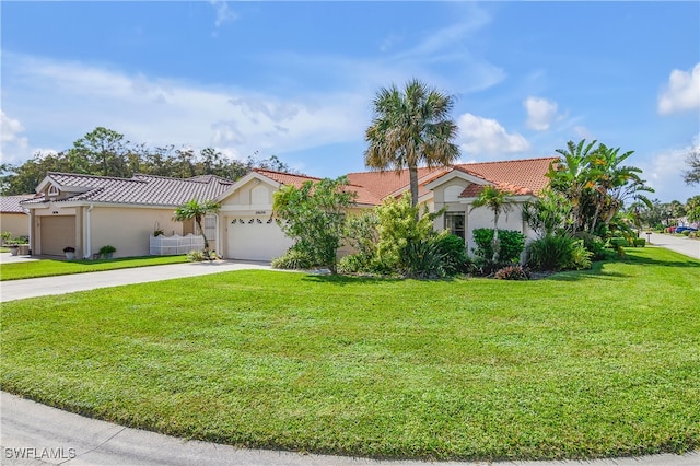 mediterranean / spanish-style home with a front lawn and a garage