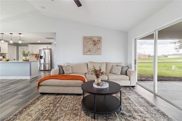 living room with lofted ceiling, ceiling fan, and dark hardwood / wood-style floors