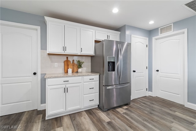 kitchen with white cabinetry, dark wood-type flooring, and stainless steel fridge