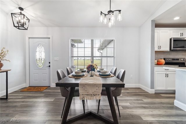 dining space featuring an inviting chandelier and dark hardwood / wood-style floors