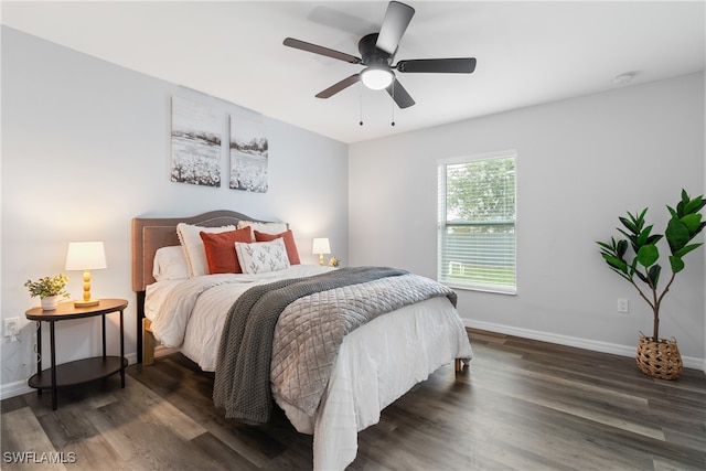 bedroom with dark hardwood / wood-style floors and ceiling fan