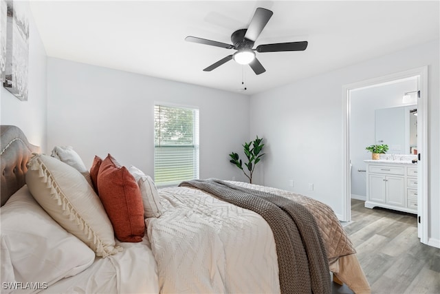 bedroom featuring light wood-type flooring, connected bathroom, and ceiling fan