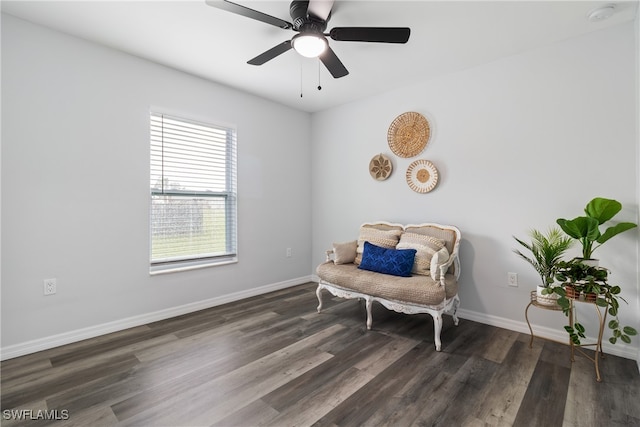 living area with ceiling fan and dark hardwood / wood-style flooring