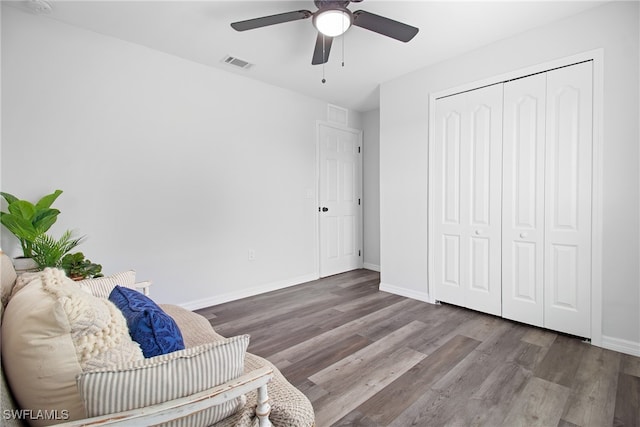 sitting room with ceiling fan and hardwood / wood-style flooring