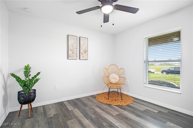 sitting room featuring ceiling fan and dark wood-type flooring