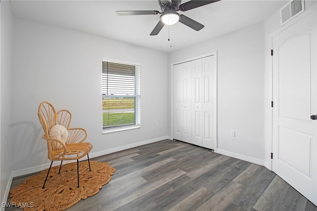 sitting room featuring ceiling fan and dark hardwood / wood-style floors