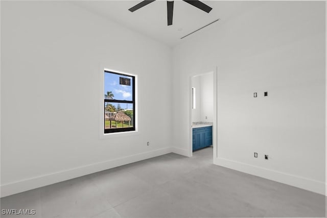 spare room featuring a ceiling fan and baseboards