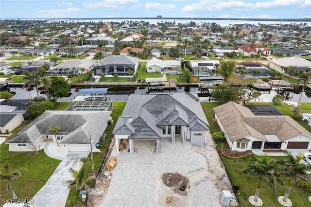 drone / aerial view with a residential view and a water view