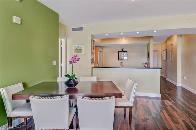 dining area with dark hardwood / wood-style floors