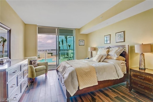 bedroom with expansive windows and dark wood-type flooring