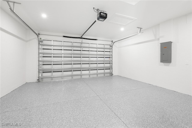 garage with electric panel and a garage door opener