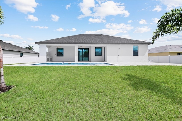 back of property with a yard and a patio area