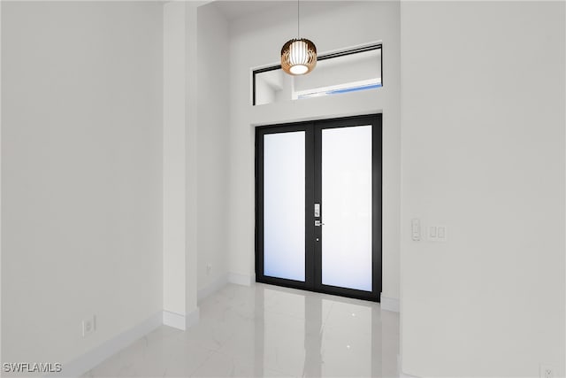 entrance foyer with french doors and a healthy amount of sunlight