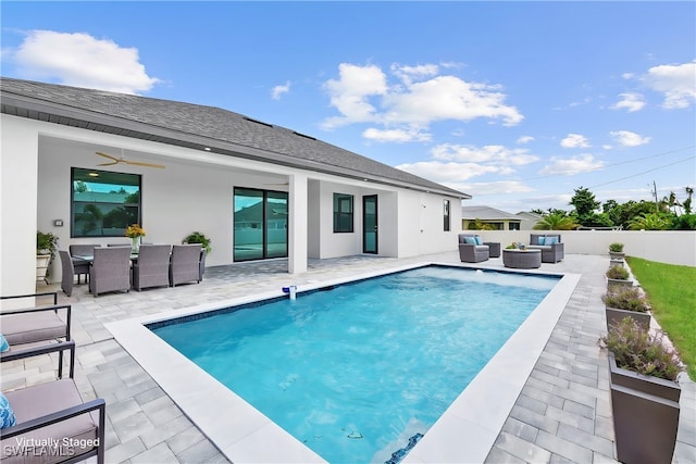 view of swimming pool featuring an outdoor living space, a patio area, and ceiling fan