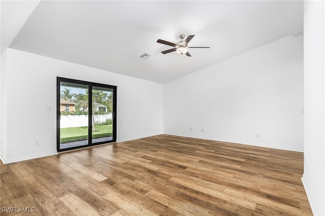 spare room with vaulted ceiling, hardwood / wood-style floors, and ceiling fan