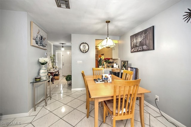 dining space featuring light tile patterned flooring