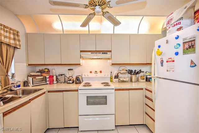 kitchen with ceiling fan, light tile patterned flooring, tasteful backsplash, white appliances, and cream cabinets