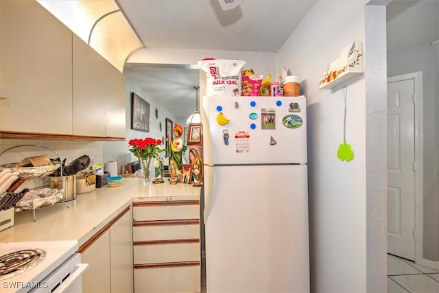 kitchen with white refrigerator and light tile patterned floors