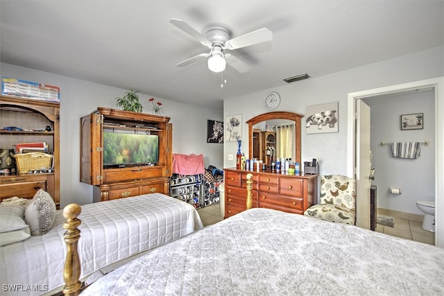 bedroom with ensuite bath, ceiling fan, and tile patterned floors