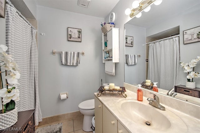 bathroom with tile patterned floors, vanity, and toilet