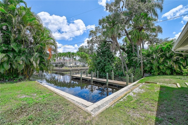 view of dock featuring a water view and a yard