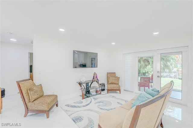 sitting room featuring light tile patterned floors and french doors