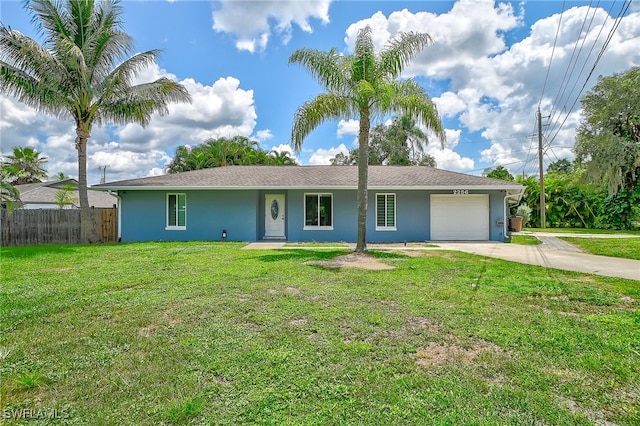 ranch-style house featuring a front lawn and a garage