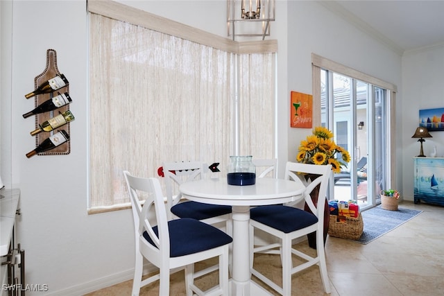 dining area featuring ornamental molding and light tile patterned floors