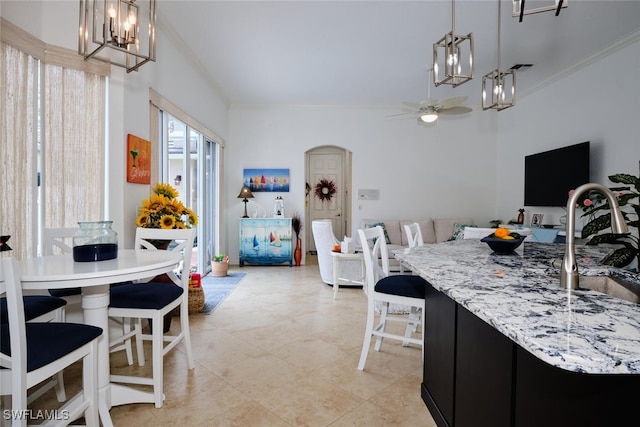 dining space with ceiling fan and ornamental molding