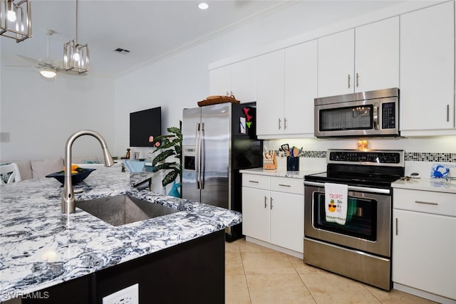 kitchen with white cabinets, decorative backsplash, sink, and appliances with stainless steel finishes