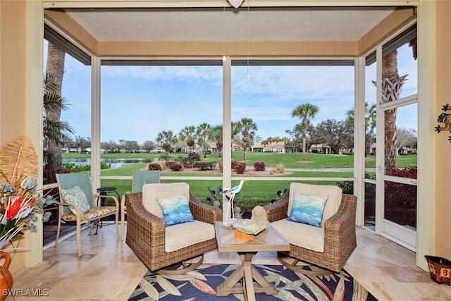 sunroom with a water view and a healthy amount of sunlight