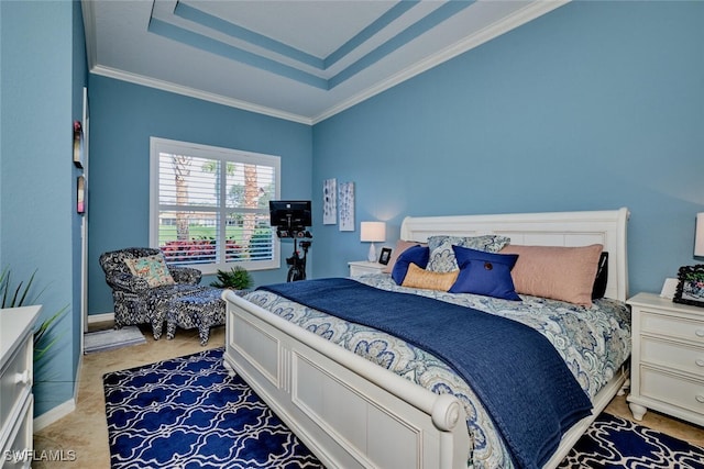 bedroom featuring ornamental molding and a tray ceiling