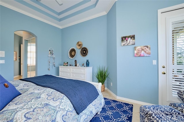 bedroom with a raised ceiling and ornamental molding