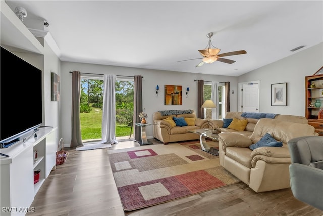 living room featuring wood-type flooring, vaulted ceiling, and ceiling fan