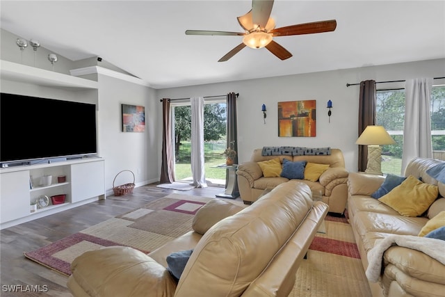 living room featuring vaulted ceiling, ceiling fan, and hardwood / wood-style floors