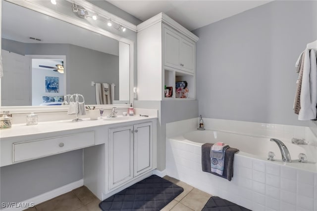 bathroom with vanity, tiled bath, tile patterned flooring, and ceiling fan