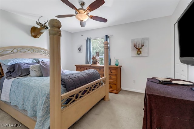 bedroom with light carpet and ceiling fan