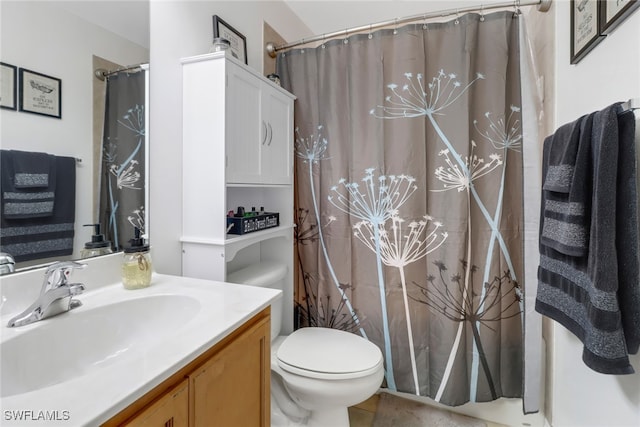 bathroom featuring tile patterned flooring, vanity, and toilet