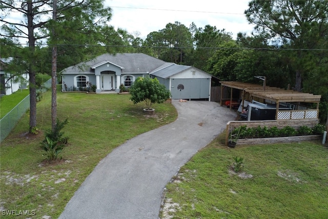 ranch-style home with a storage shed and a front lawn