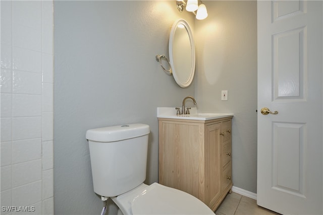 bathroom featuring tile patterned floors, vanity, and toilet