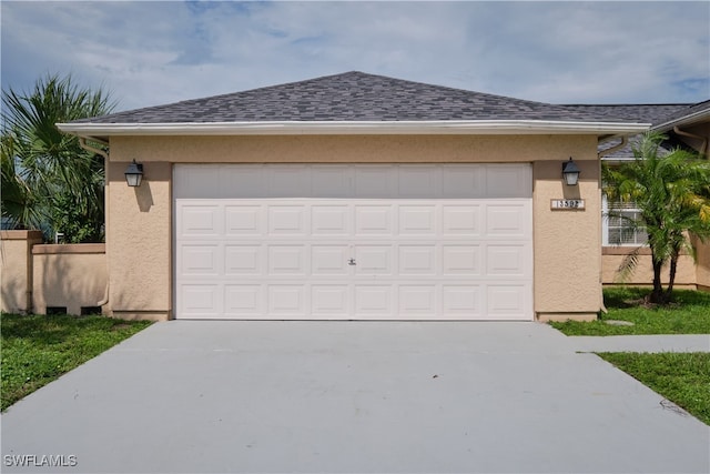 garage featuring concrete driveway