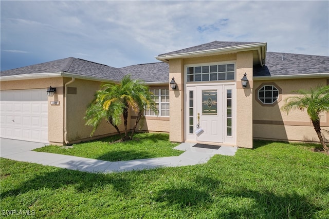 exterior space featuring a garage, a yard, roof with shingles, and stucco siding