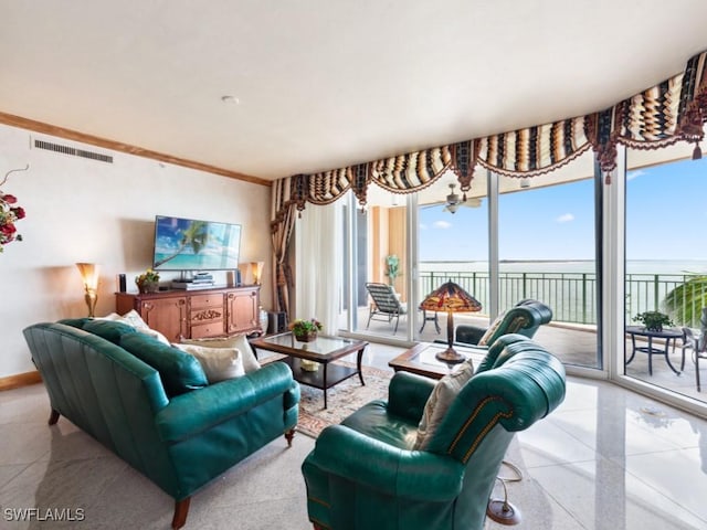 970 Cape Marco Dr Unit 402, Marco Island, FL 34145 - living area with visible vents, baseboards, light speckled floor, and crown molding