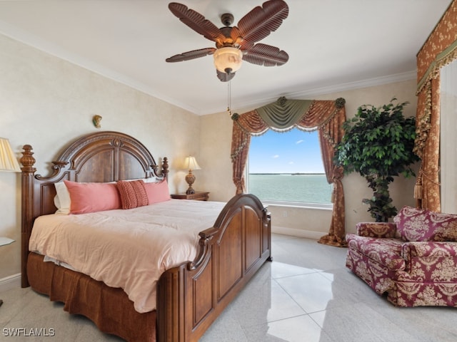 bedroom with a water view, crown molding, and ceiling fan