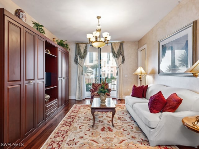 living room with a notable chandelier and dark hardwood / wood-style flooring